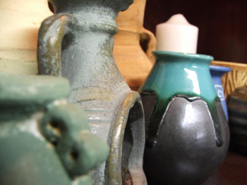 Pictured is a display of assorted pieces of pottery ... all having different forms and functions.  Photographer unknown.